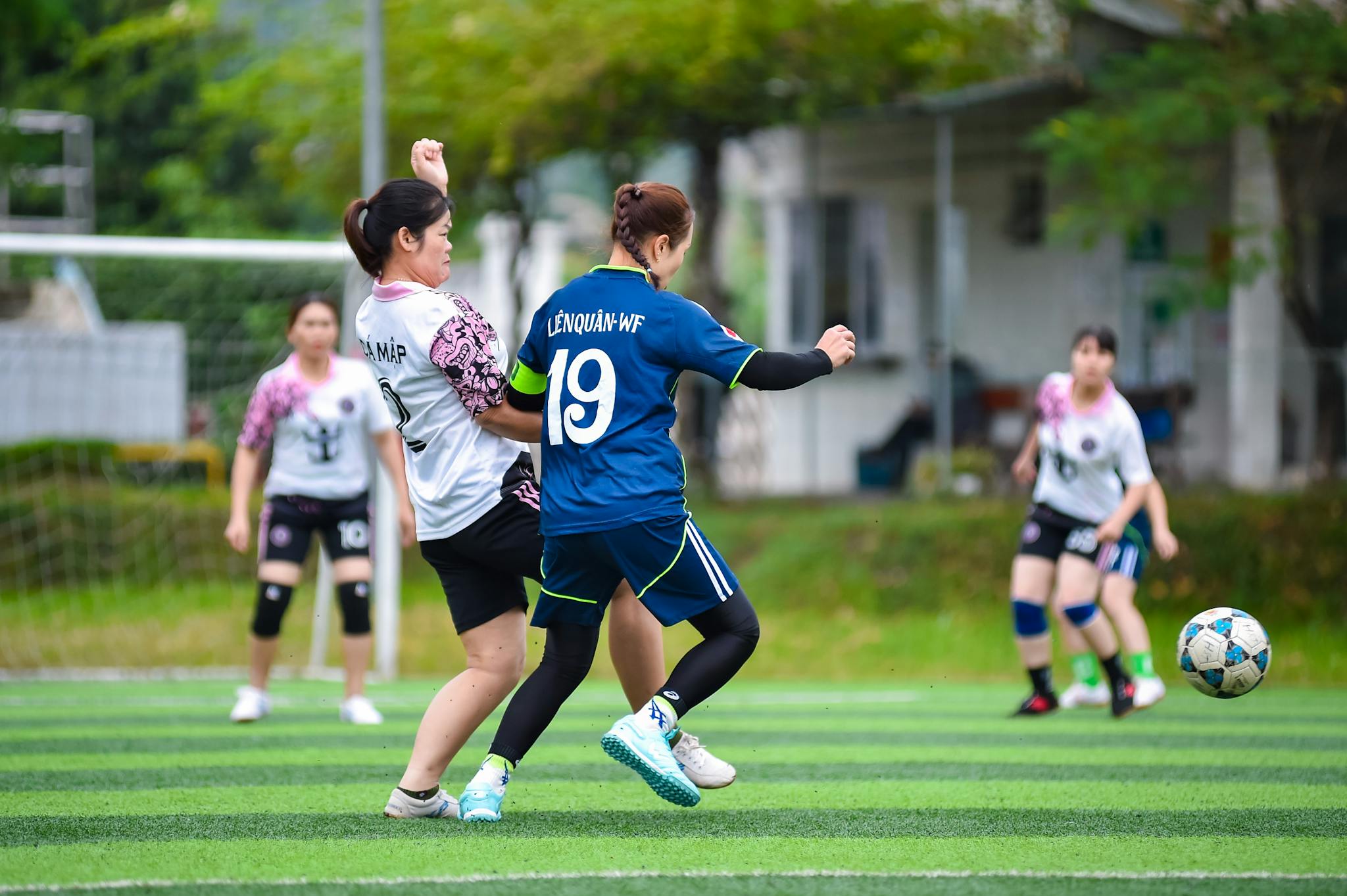 Exciting women's football action capturing team spirit on a vibrant field in Hà Nội, Vietnam.